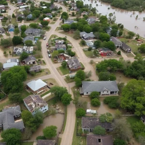 Overview of a flooded area in Texas Hill Country with submerged homes and debris.