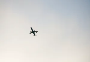 An airplane in the sky representing aviation and remembrance