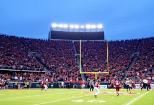 Collegiate football game with players and fans in an overtime setting.
